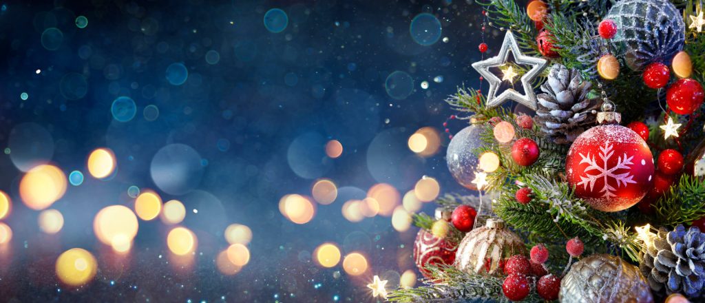 Holiday image of blue background with parts of a christmas tree