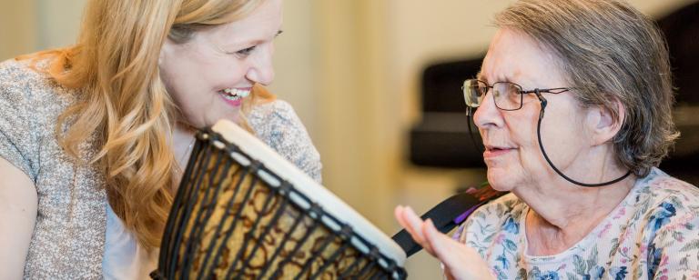 Senior woman playing drum