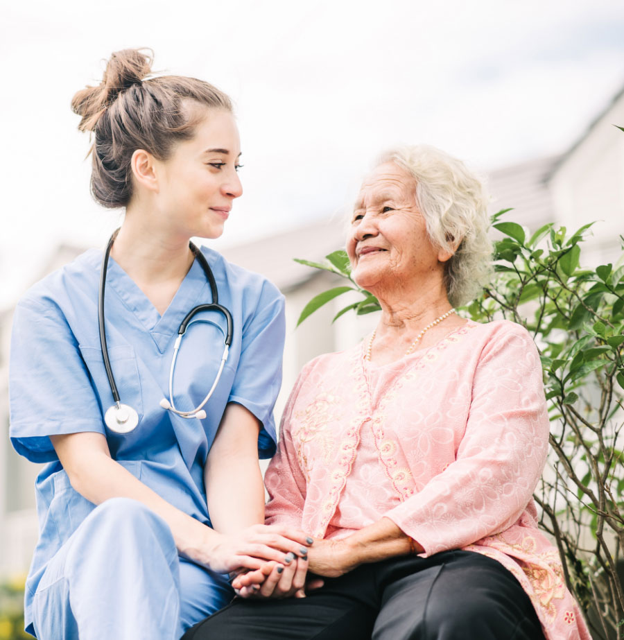 Senior woman talking with nurse