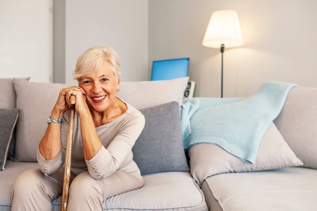Senior Woman Smiling While Sitting on Her Couch