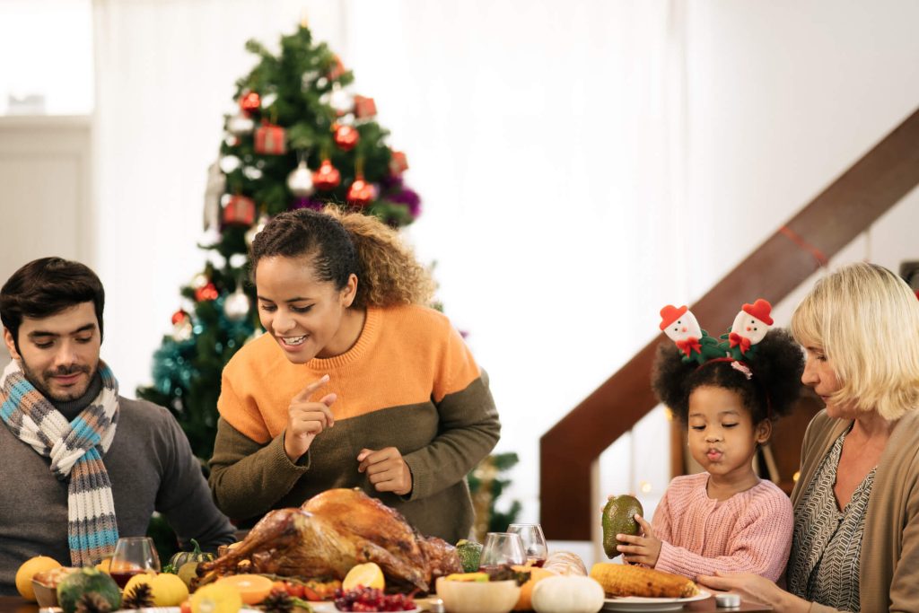 Family looking over thanksgiving turkey in delight