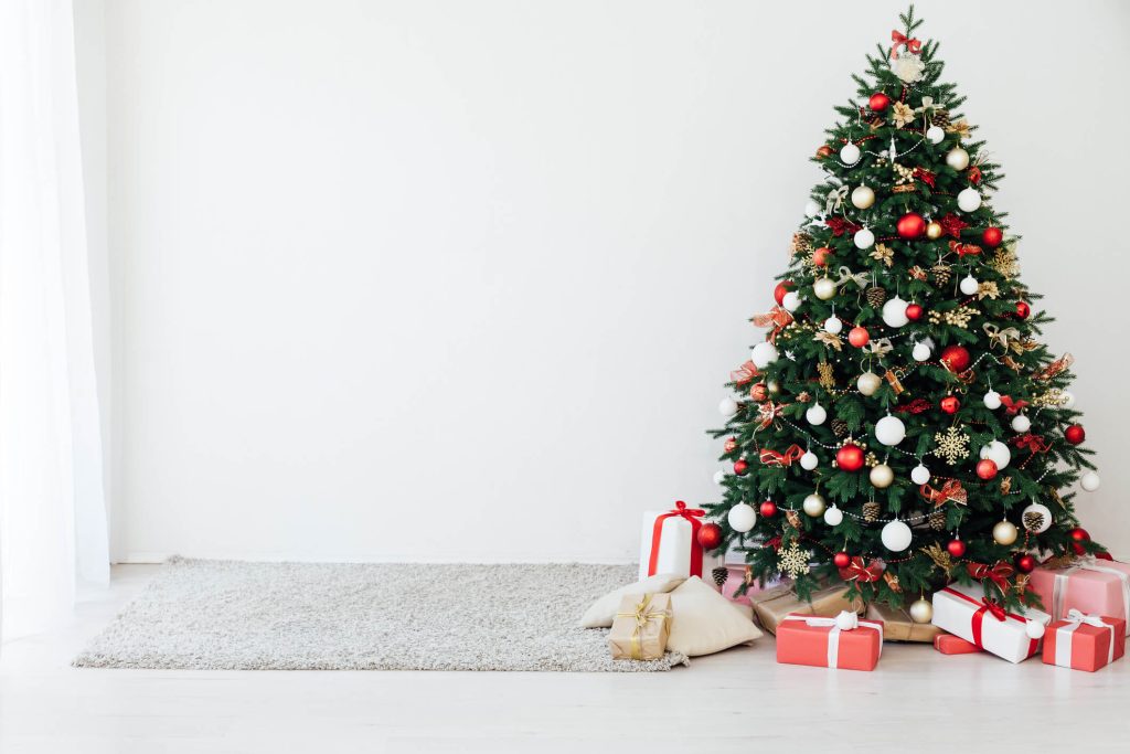 Decorated christmas tree in front of white background